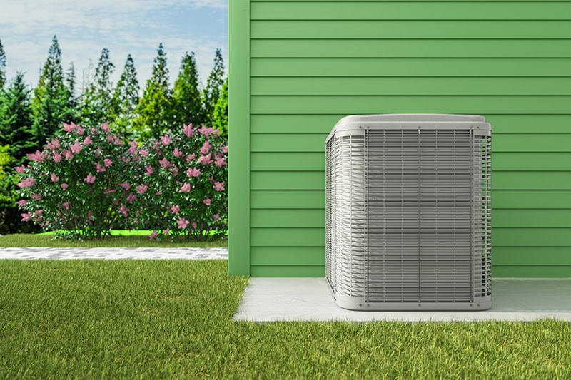 air conditioner sitting on the outside of a home.